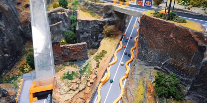 An image of Marbles roll down a ramps